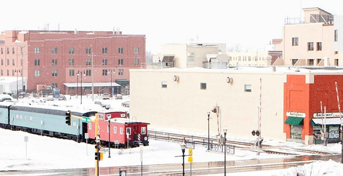 a train on a track in a snowy city